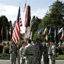 U.S. Army Brig. Gen. William Troy, center left, accepts flags signifying the command of the I Corps and Fort Lewis from Gen. Charles C. Campbell, center, the head of the Atlanta-based U.S. Army Forces Command, during a relinquishment of command ceremony Monday, April 30, 2007, at Fort Lewis, Wash. Troy will serve as interim commander of Fort Lewis, replacing Lt. Gen. James Dubik, center right, until a permanent replacement for Dubik can be confirmed by the Senate Armed Services Committee. Dubik has been assigned to take over leadership of the Multi-National Security Transition Command in Iraq. (AP Photo/Ted S. Warren)